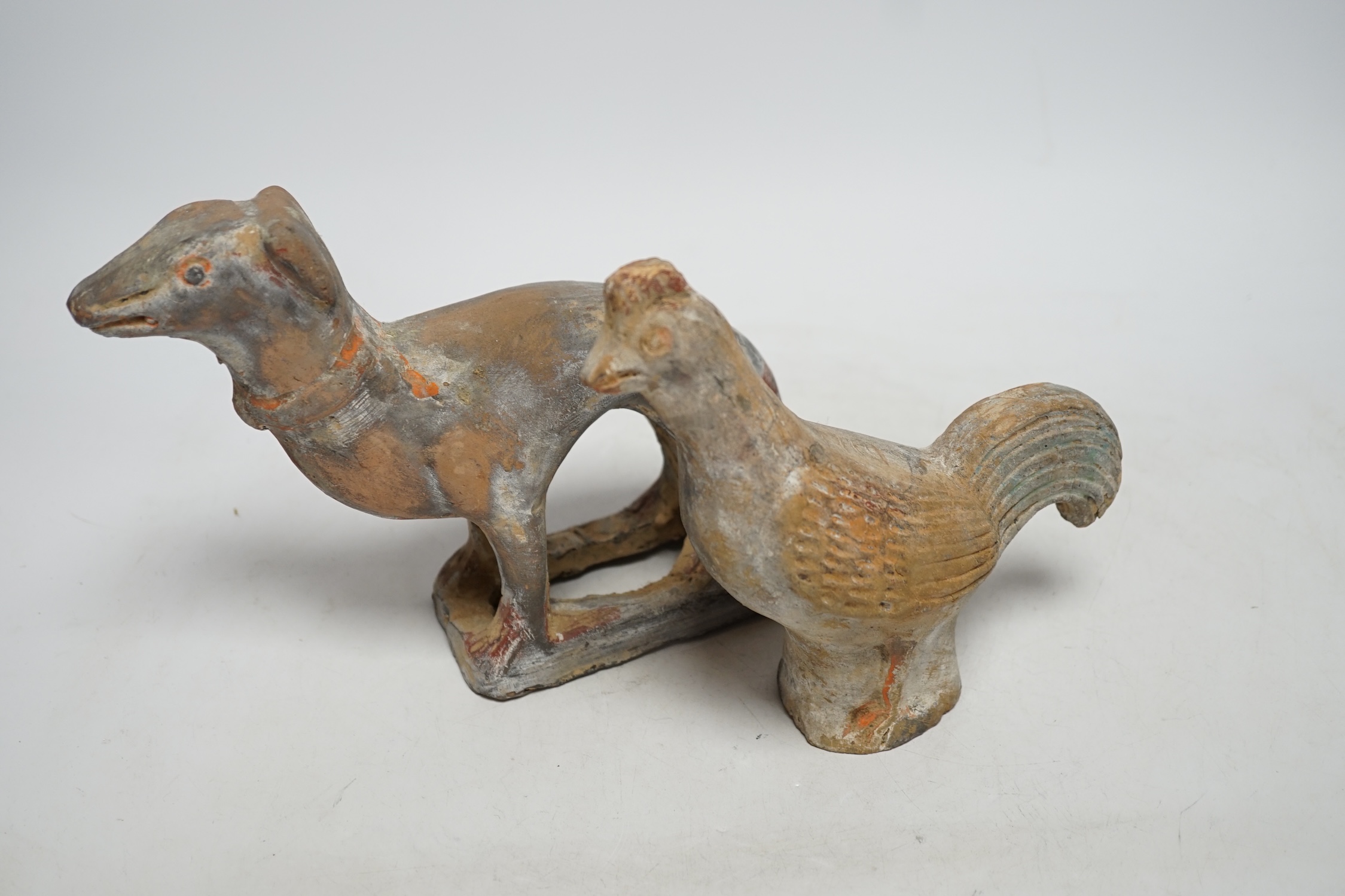 Two Chinese pigment painted figures of a cockerel and a dog, Han dynasty or later, 17cm